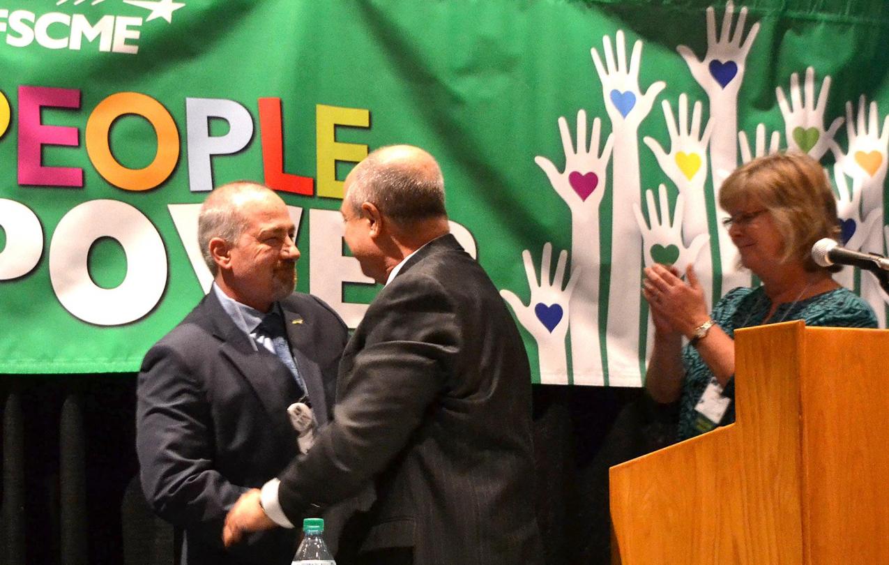 AFSCME Council 5 executive director Eliot Seide (center), who is retiring, and president Judy Wahlberg welcome the new executive director, John Westmoreland (left).