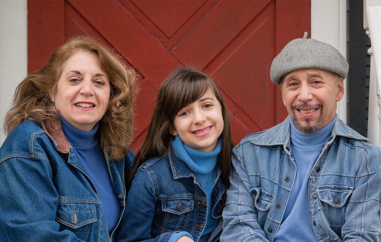 An image of parents and child smiling.